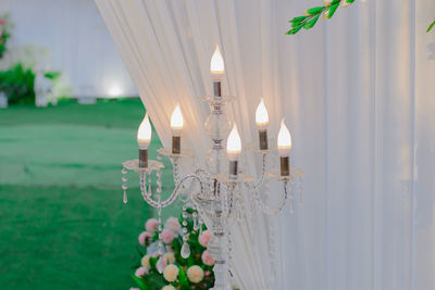 Close-up of illuminated lighting equipment on glass