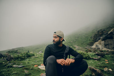 Side view of man standing against mountain