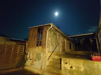 Low angle view of illuminated building against sky at night