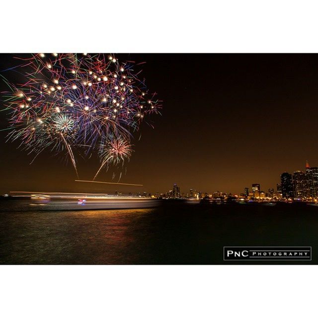illuminated, night, water, building exterior, city, clear sky, firework display, celebration, sky, waterfront, built structure, architecture, sea, river, long exposure, cityscape, arts culture and entertainment, exploding, copy space, multi colored