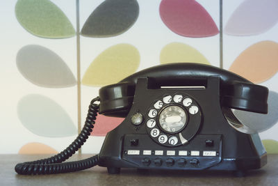 Close-up of telephone booth on table