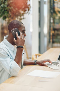 Young man using laptop on table