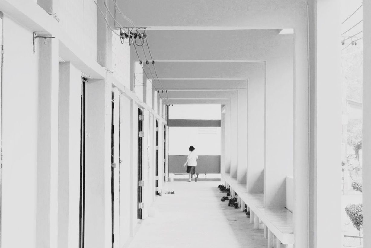 indoors, men, architecture, walking, lifestyles, built structure, corridor, rear view, person, full length, leisure activity, in a row, the way forward, ceiling, day, diminishing perspective, building, standing