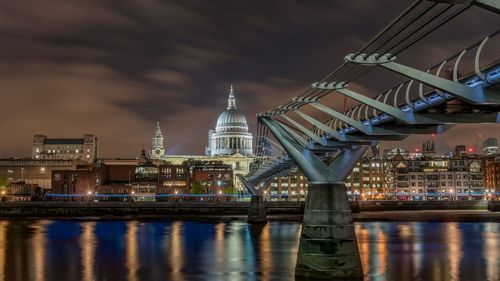 Illuminated bridge over river against st.pauls cathedral at night