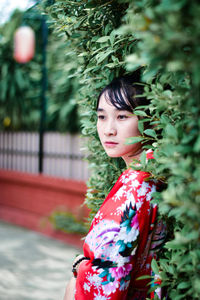 Portrait of smiling young woman standing outdoors