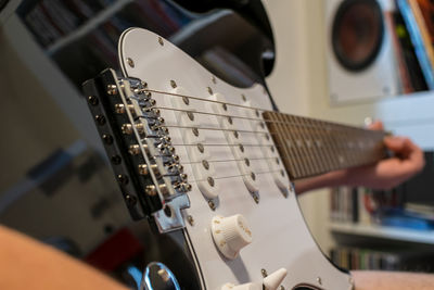 Close-up of cropped hand playing guitar