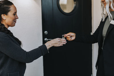 Female estate agent giving woman keys