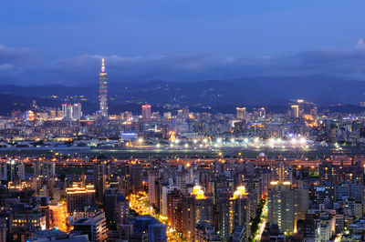 High angle view of city lit up at night