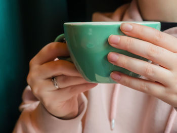 Close-up of woman holding coffee cup