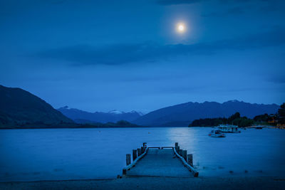 Scenic view of lake against sky at night