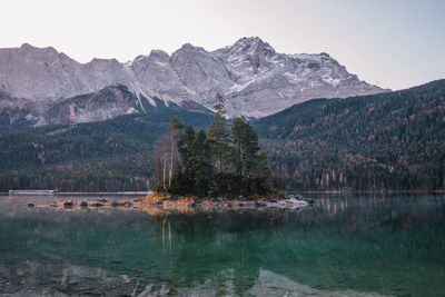 Scenic view of lake and mountains against sky