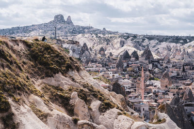 Aerial view of city against cloudy sky