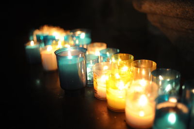 Close-up of lit tea light candles on table