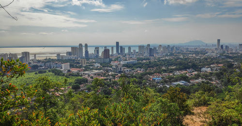 High angle view of buildings against cloudy sky