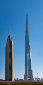 View of skyscrapers against clear blue sky