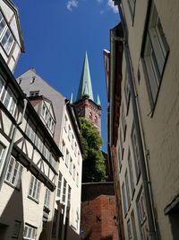 Low angle view of buildings in town against sky