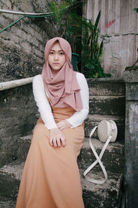 Portrait of young woman standing outdoors