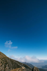 Scenic view of mountains against blue sky