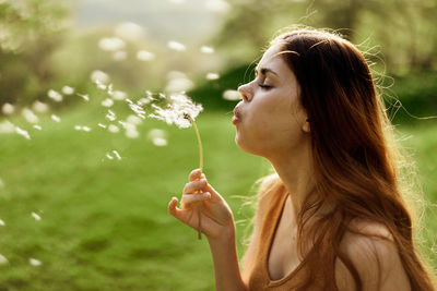 Young woman blowing bubbles