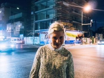 Portrait of woman standing in city