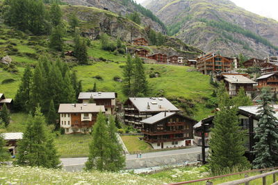 Houses on hill against mountain at zermatt