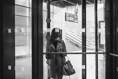 Woman standing by door