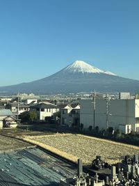 Boats in sea against clear blue sky