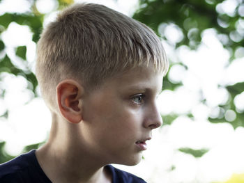 Close-up of boy looking away outdoors