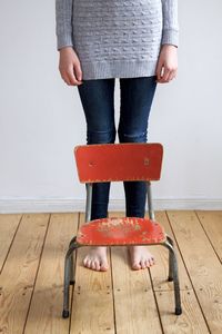 Low section of woman standing on hardwood floor