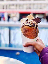 Close-up of hand holding ice cream cone