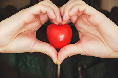 Close-up of woman holding heart shape