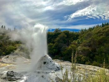 Scenic view of waterfall against sky