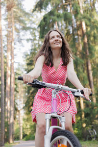 Portrait of young woman riding bicycle