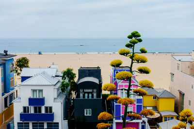 Buildings at beach against sky