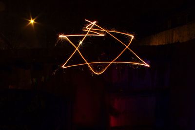 Light painting against sky at night