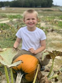 Portrait of smiling boy on field