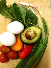 Close-up of vegetables with avocado and egg on table