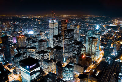 High angle view of city lit up at night