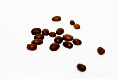 Close-up of coffee beans against white background