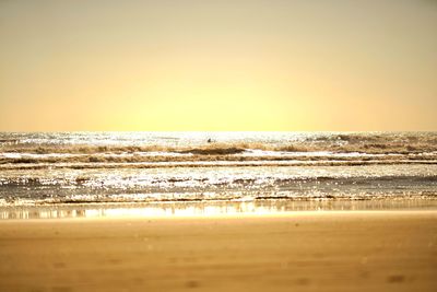 Scenic view of sea against clear sky during sunset