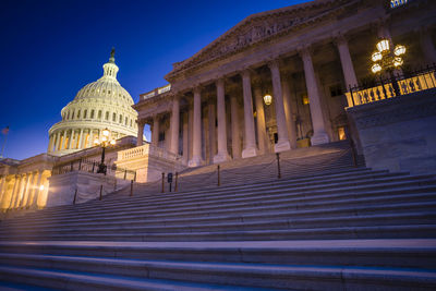 Low angle view of illuminated building against sky at night