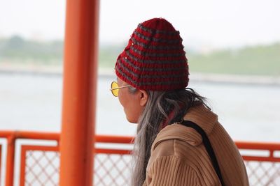 Portrait of woman with umbrella on railing