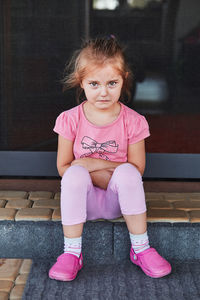 Full length portrait of cute girl crying