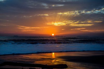 Scenic view of sea against romantic sky at sunset