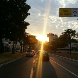 Traffic on road at sunset