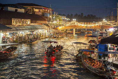 Boats in canal at night