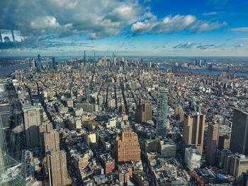 Aerial view of modern buildings in city against sky