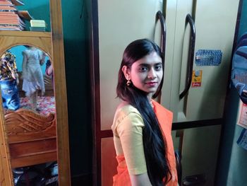 Portrait of young woman standing in store