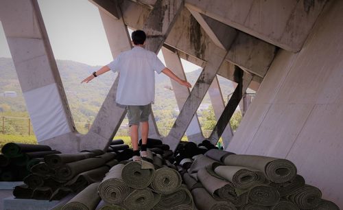 Rear view of man standing on matting under stadium