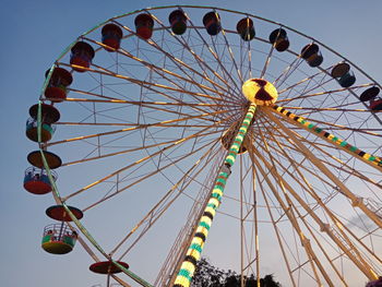 Low angle view of ferris wheel against sky